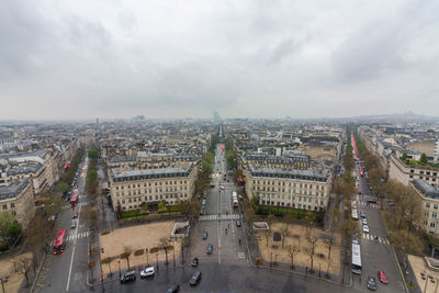High angle view of city street against cloudy sky