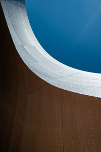 Low angle view of swimming pool against clear blue sky