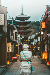 Rear view of woman walking in city