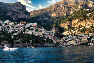 Positano, scenic view of sea by town against sky