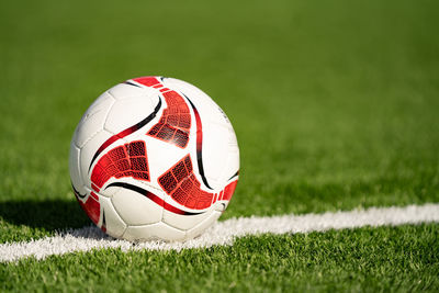 Close-up of soccer ball on field