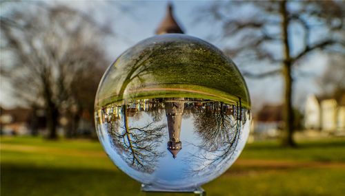 Reflection of tower on crystal ball at park