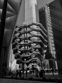 Low angle view of modern buildings in city against sky