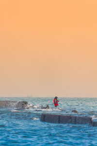 Scenic view of sea against clear sky during sunset