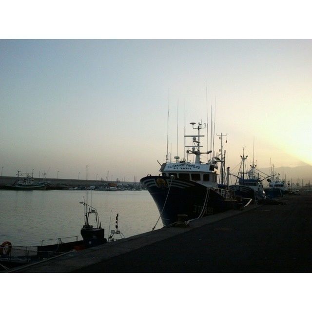 transportation, nautical vessel, mode of transport, transfer print, boat, water, moored, auto post production filter, clear sky, copy space, sunset, mast, sea, harbor, sky, silhouette, nature, outdoors, no people, river