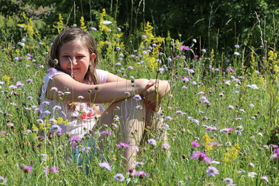 Girl in a meadow amongst wild flowers