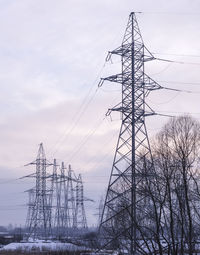 Low angle view of electricity pylon against sky