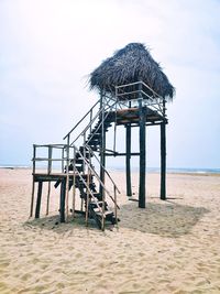 Lifeguard hut on beach against clear sky