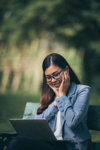 Young woman using mobile phone outdoors