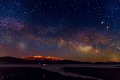 Scenic view of lake against star field at night