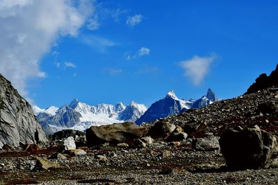 Panoramic view of snowcapped mountains against blue sky