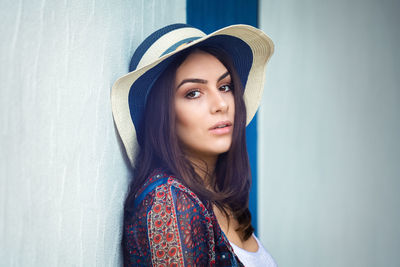 Close-up portrait of young beautiful girl with hat