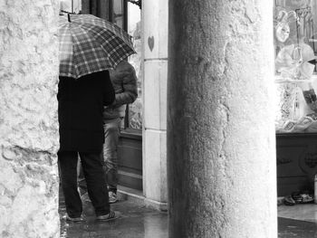 People standing by column