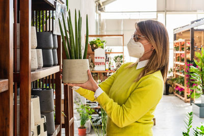 Side view of woman standing in a store
