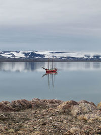 Sailboat in sea against sky