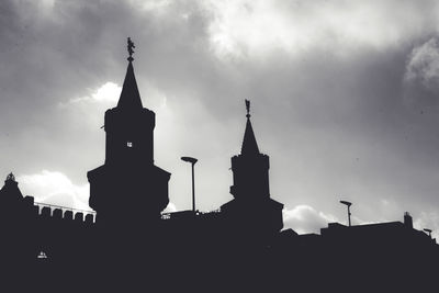 Low angle view of silhouette buildings against sky