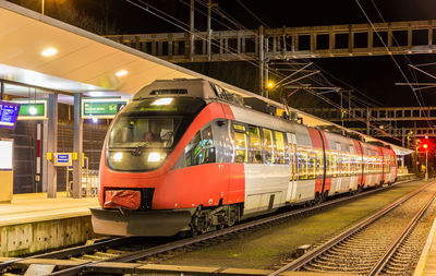 Train on railroad tracks in city against sky