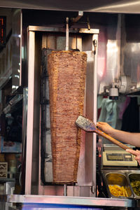 Cropped hand of man preparing food