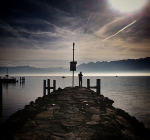 Pier on sea at sunset