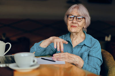 Senior woman sitting in cafe