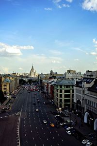 High angle view of city street against cloudy sky