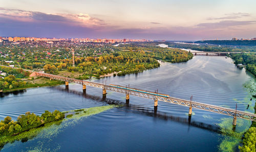 High angle view of river amidst city against sky