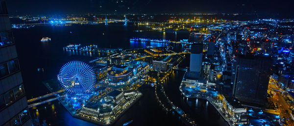 High angle view of illuminated city buildings at night