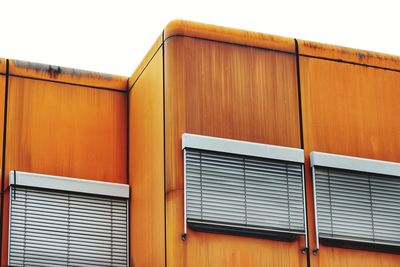 Close-up of orange building against sky