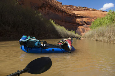 People float packrafts lazily down escalante river, utah