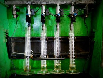 Close-up of green bottles in factory