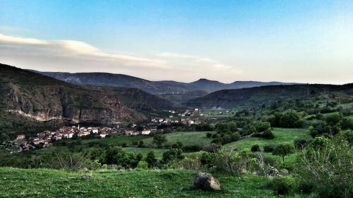 Scenic view of landscape and mountains against sky