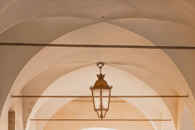 Low angle view of illuminated lamp in building