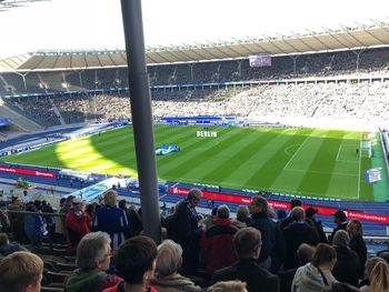 Group of people looking at soccer field