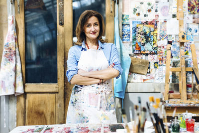 Confident mature woman in own textile workshop