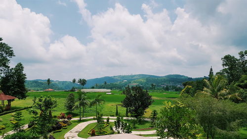 Scenic view of field against cloudy sky