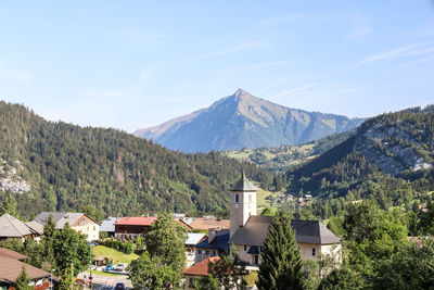 Scenic view of mountains and buildings against sky