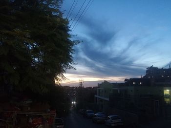 Vehicles on road at sunset