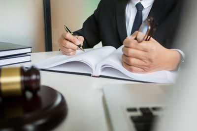 Midsection of man working on table