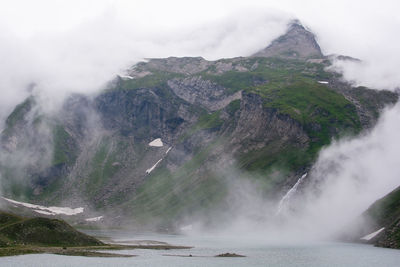 Scenic view of waterfall against sky