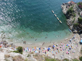 High angle view of people enjoying at beach