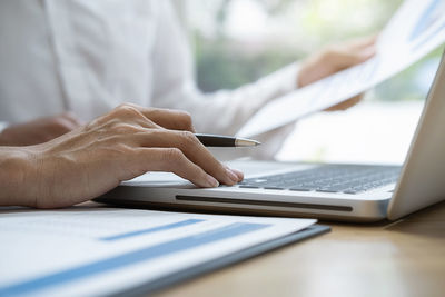 Midsection of business people working in office