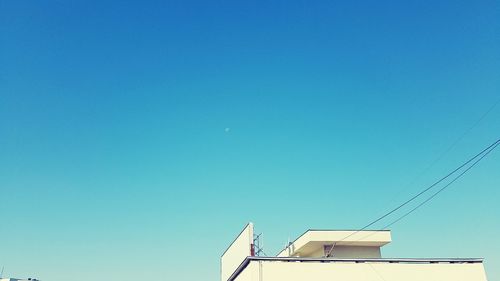 Low angle view of moon against blue sky