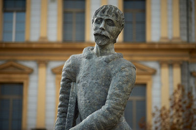 Low angle view of statue against building in city