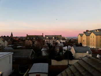 Buildings in city at sunset