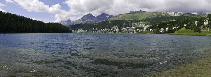 Scenic view of sea and mountains against sky