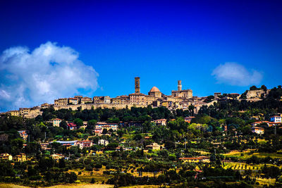 Low angle view of buildings against blue sky