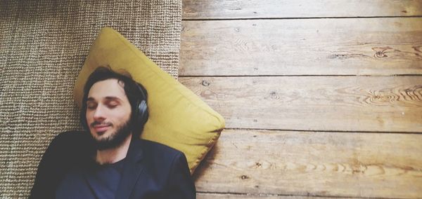 Portrait of young man relaxing on floor at home