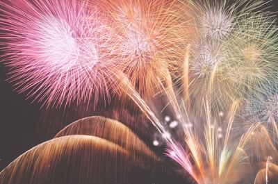 Low angle view of firework display in sky at night