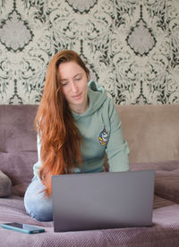 Young woman using laptop at home