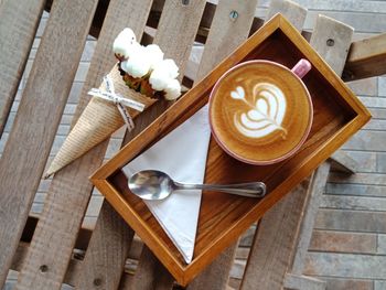 Coffee latte on a wooden tray